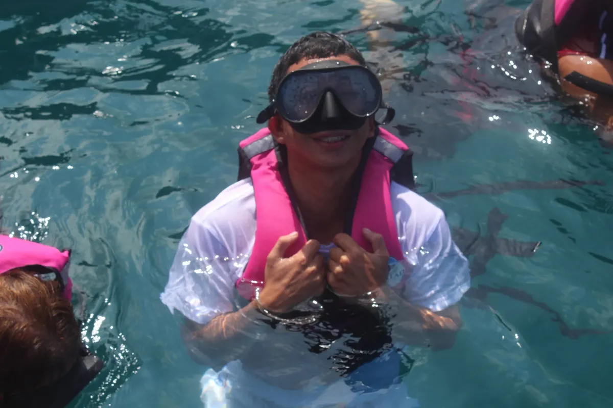 Guest smiling in snorkeling gear and a life vest