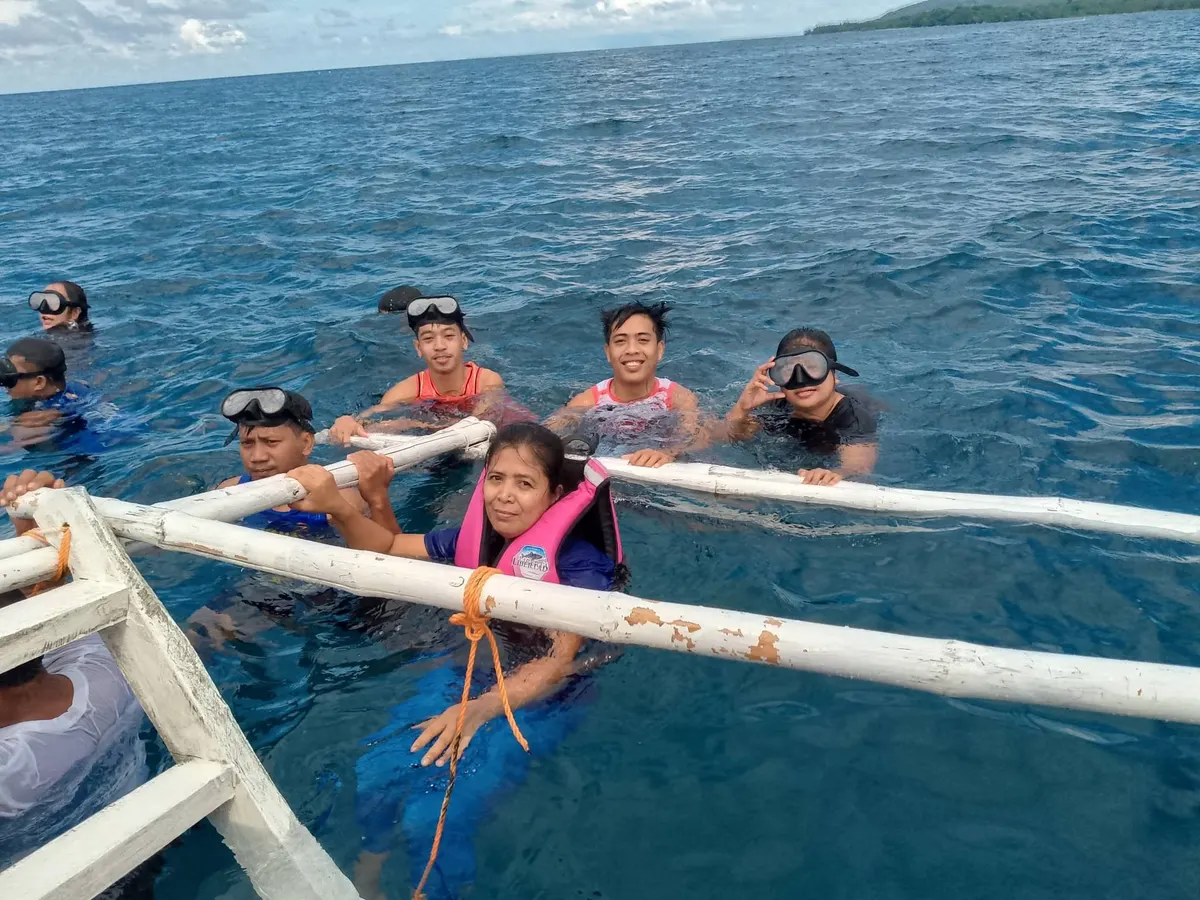 Guests holding onto the boat rail in the sea