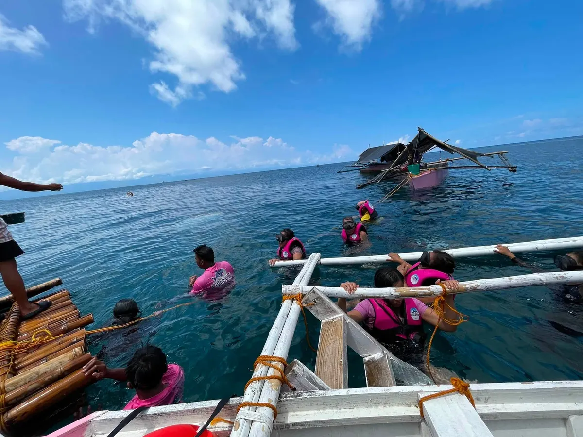 Guests preparing to swim near a tour boat
