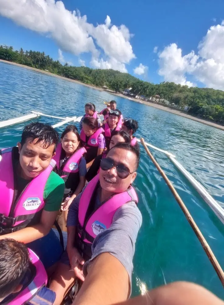 Guests riding a boat across calm blue water