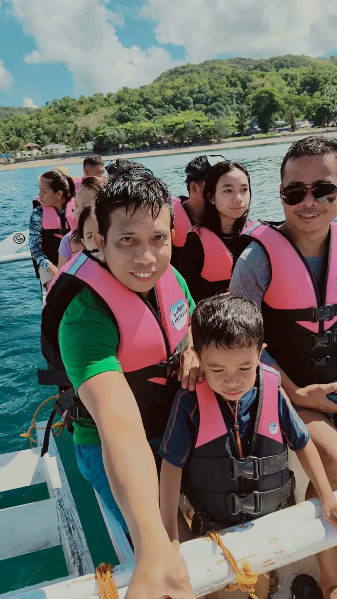 Family selfie on a boat near the Libertad shoreline