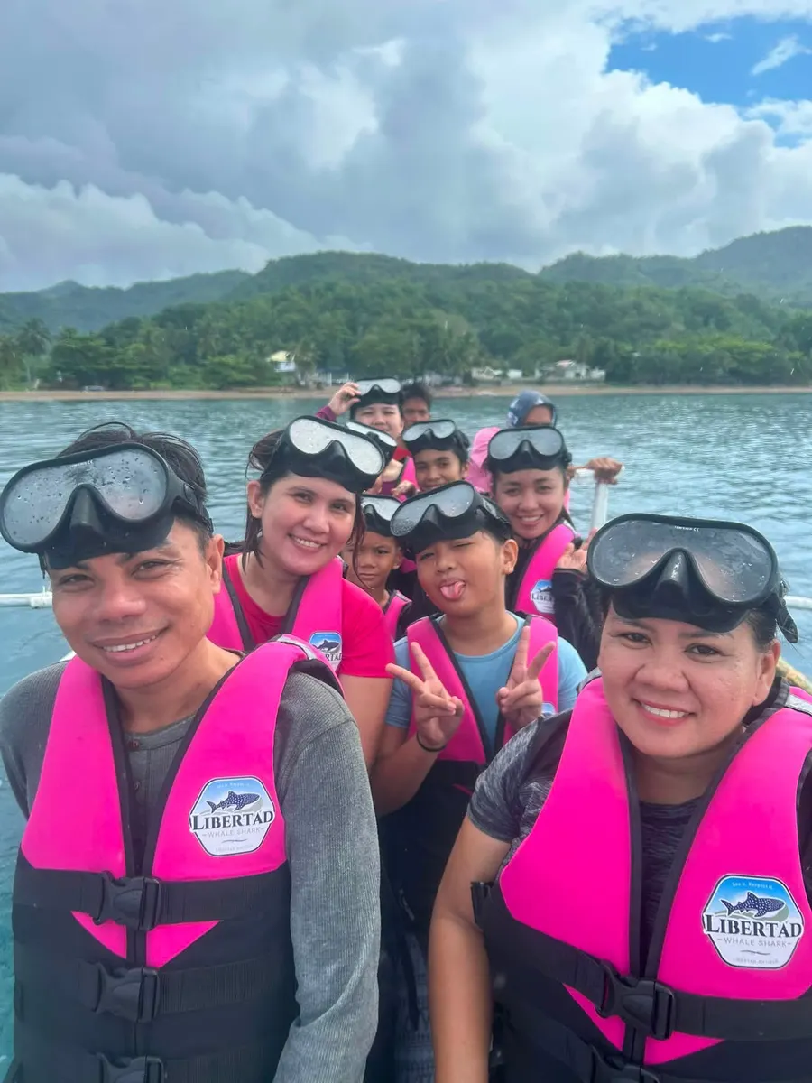 Family guests smiling together on a boat