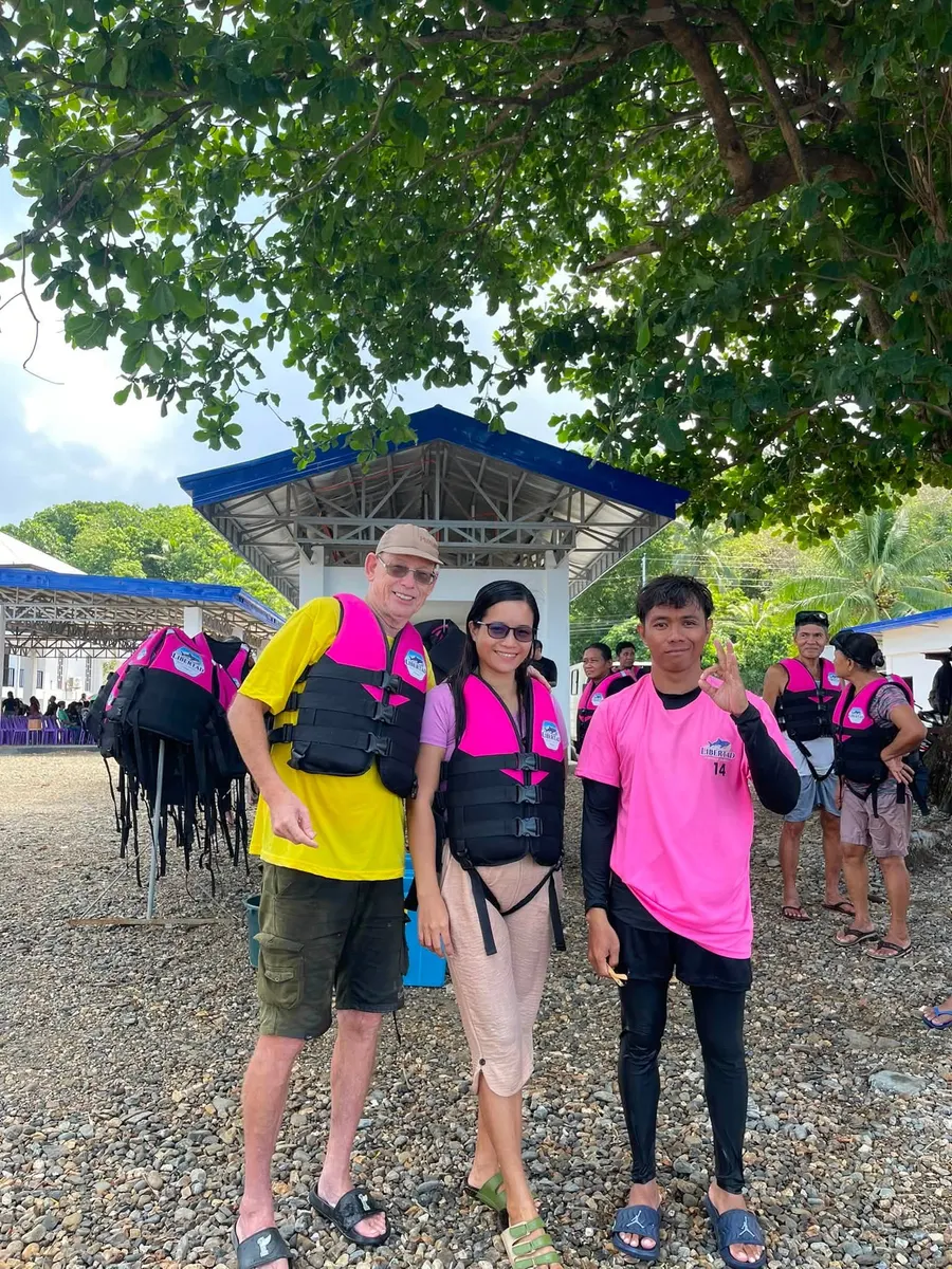 Guests posing with staff near the tour facility