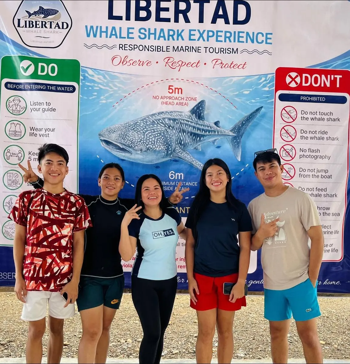 Guests posing in front of Libertad Whale Shark signage