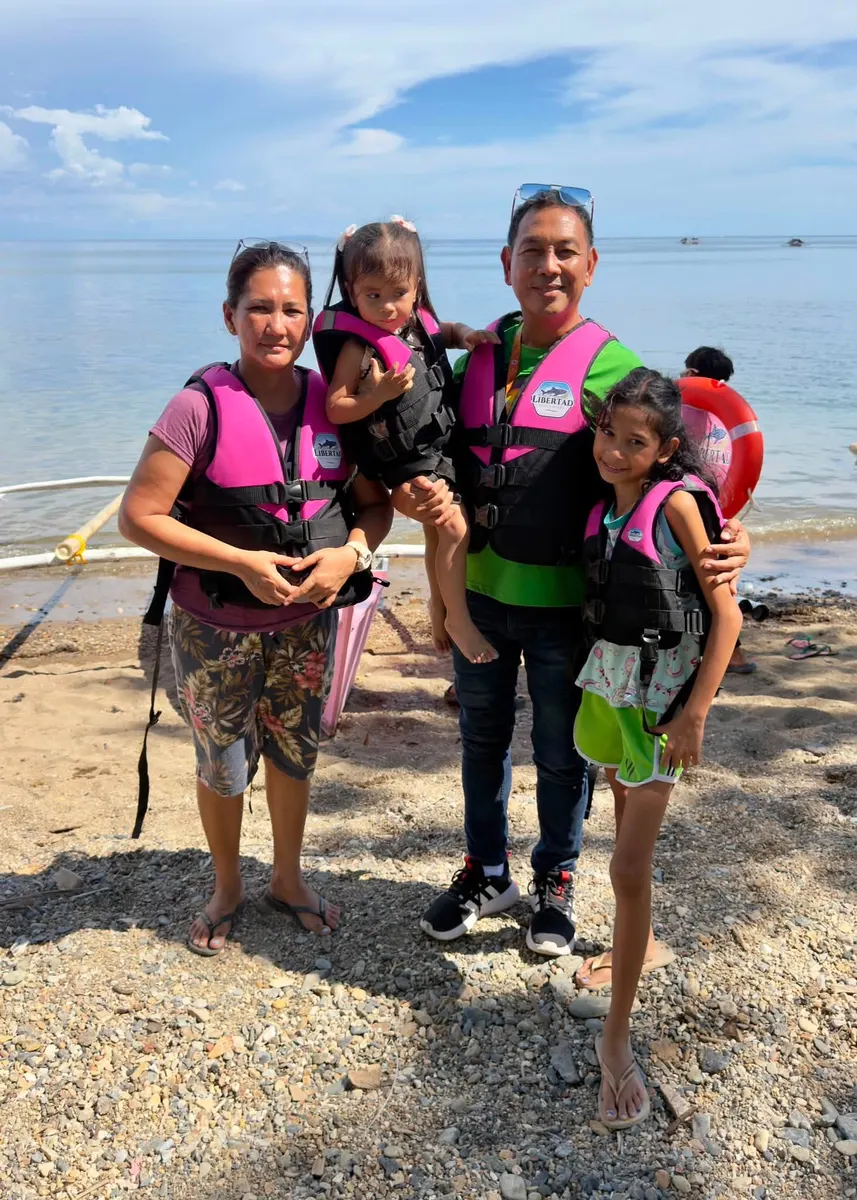 Family guests posing on the beach after the tour